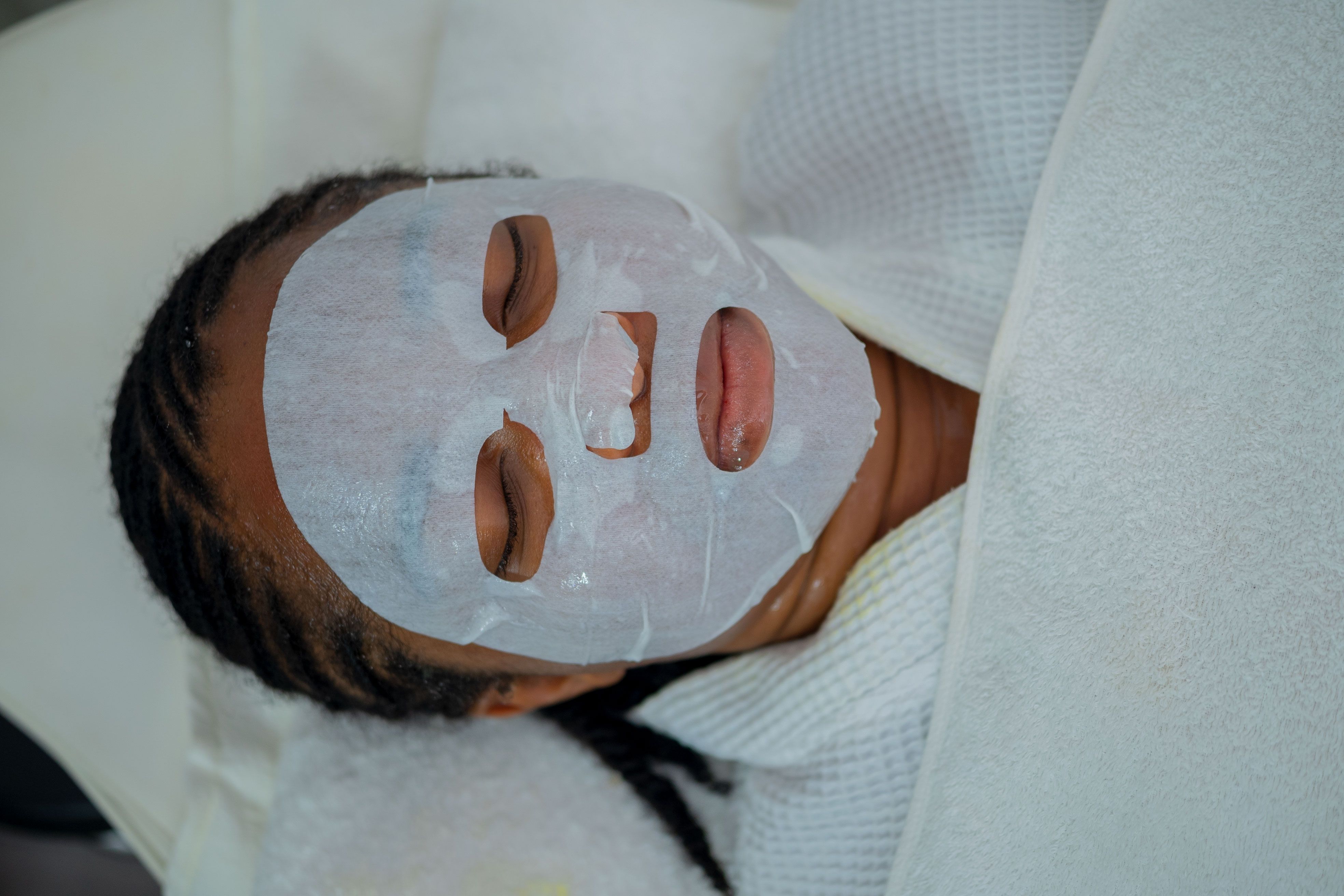 Woman enjoying a rejuvenating facial mask treatment at a spa