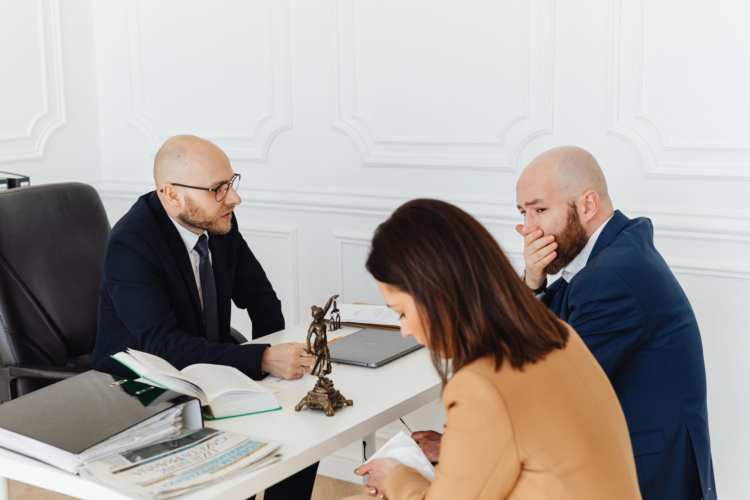 Legal professionals in a consultation discussing litigation funding disclosure in a professional office
