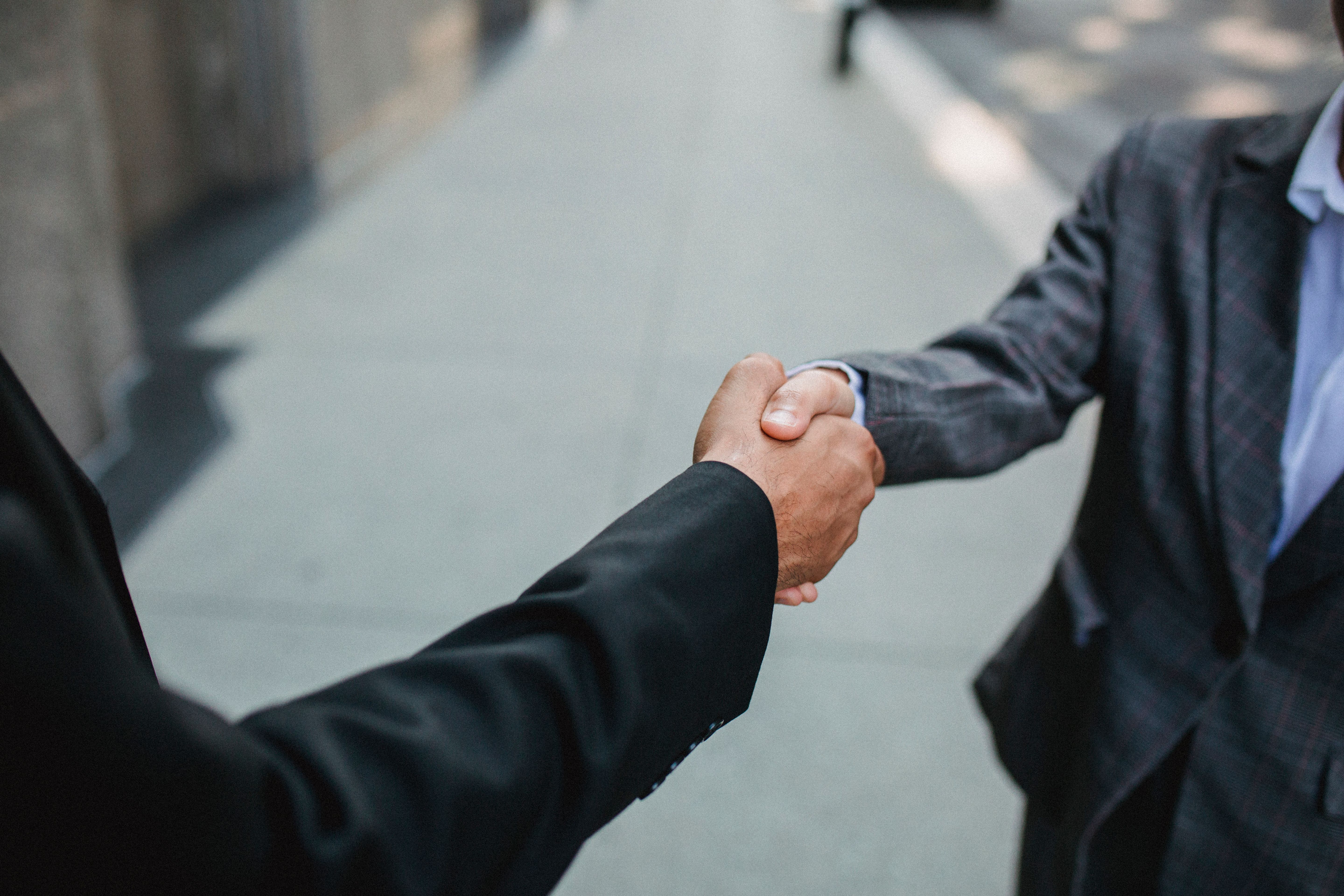 Two businessmen shaking hands on a litigation funding investment deal