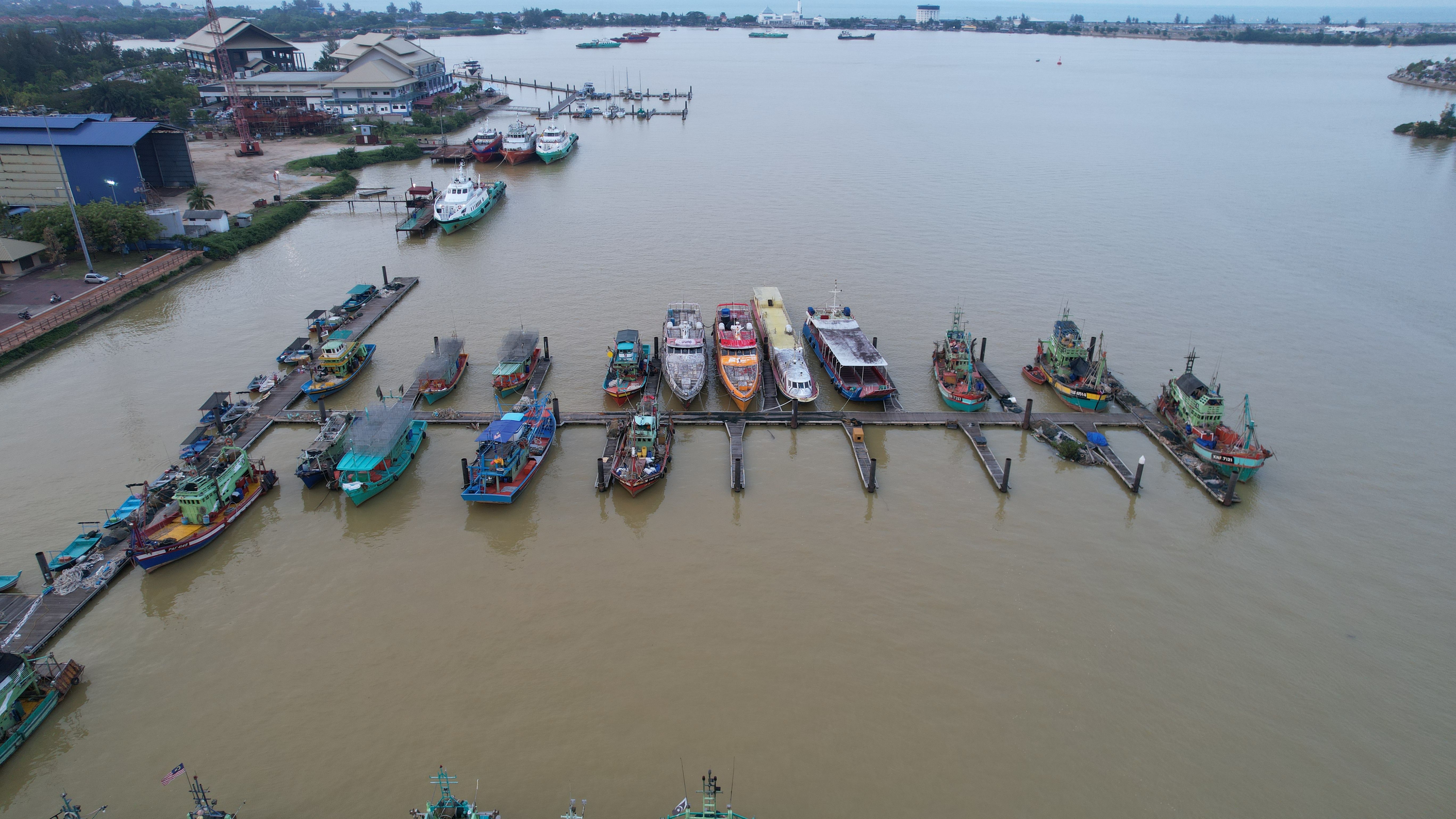 Fishing boats docked at a harbor in Kuala Terengganu, Malaysia.