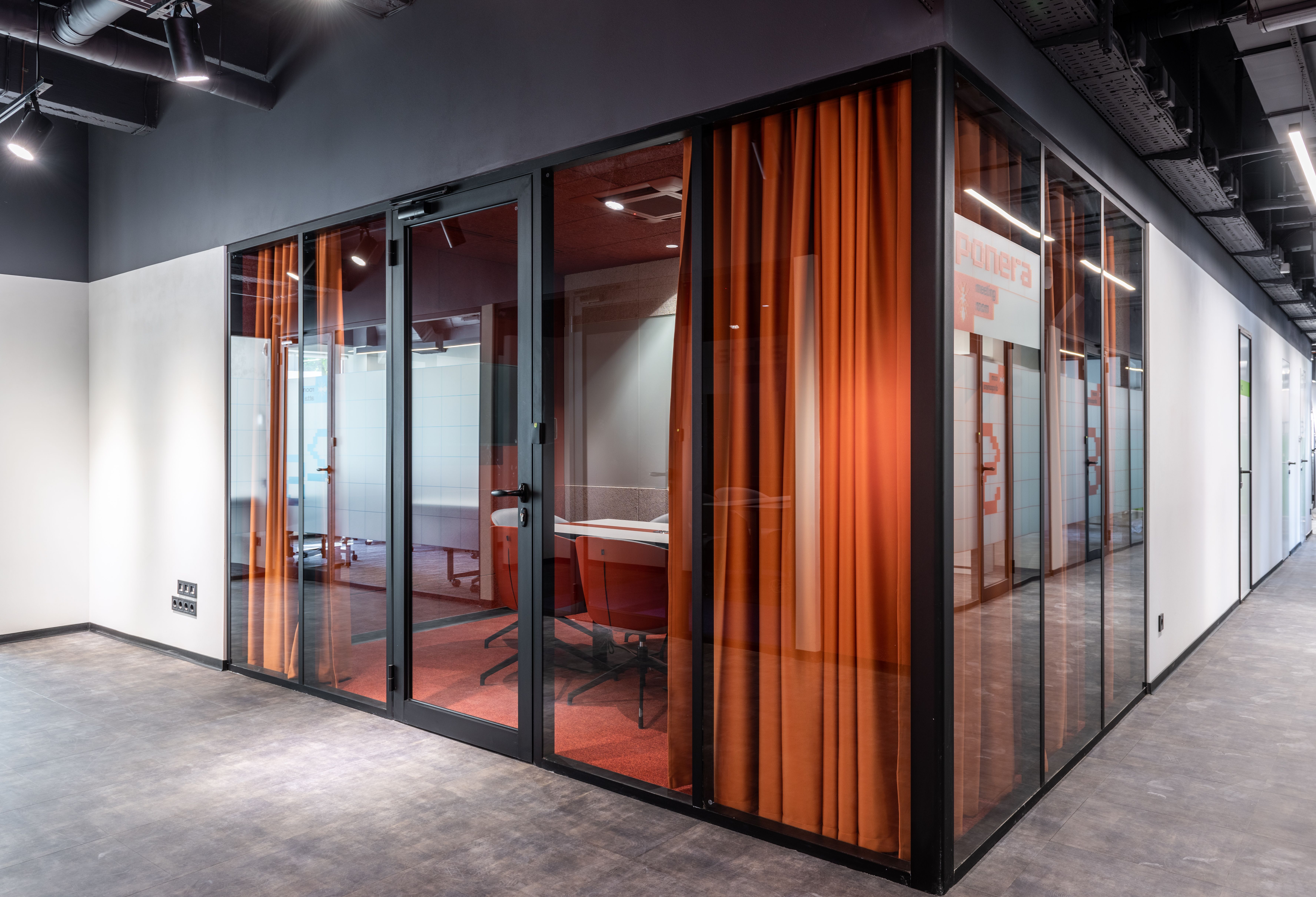 Spacious contemporary business center with glass walls and modern office seating